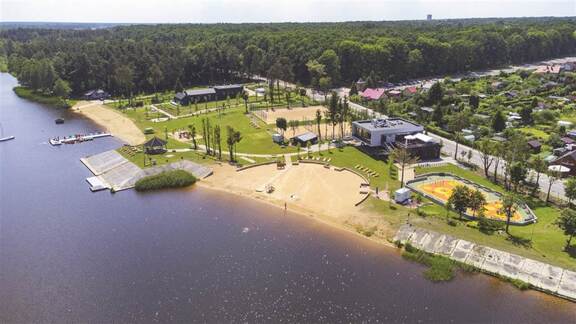 Widok z lotu ptaka na staw oraz plażę i budynki